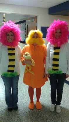 three people dressed in costumes standing next to each other