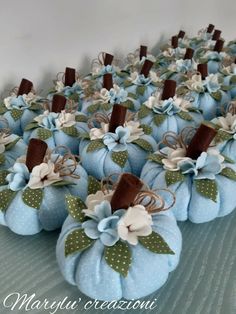 several blue pumpkins with bows and ribbons on them