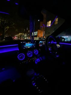 the interior of a car is lit up with blue lights