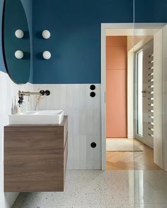 a bathroom with blue walls and white tiles