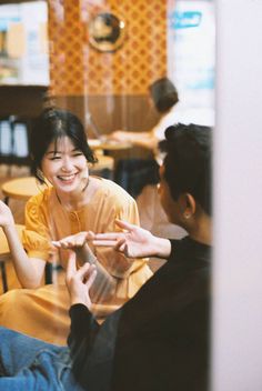 two women sitting at a table talking to each other