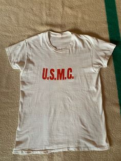 Unique USMC Howitzer Battery t shirt. 100 % cotton, single stitch, tube knit. Vintage style sleeves. A few condition issues shown in photos. Size marked large but please refer to the actual measurements: 19 inches from pit to pit measured lying flat, 17 inches across the shoulders, overall length is 27 inches. Vintage Logo Print T-shirt, Vintage Cotton Crew T-shirt, Vintage Cotton Crew Neck T-shirt, Retro Crew Neck T-shirt Made In Usa, Retro Cotton T-shirt Made In Usa, Vintage Cotton Pre-shrunk T-shirt, Vintage Crew Neck T-shirt Made In Usa, Vintage Crew Neck Graphic Print Top, Vintage Crew Neck Top With Graphic Print