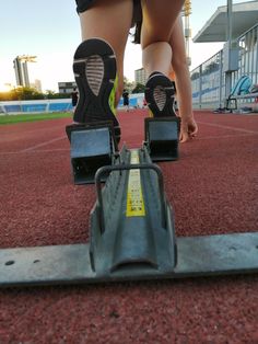 a close up of a person's feet on roller skates in a track