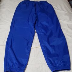 Windbreaker Joggers With Elastic Ankles. Fabric Is On The Stiffer Side, They Make A Little Noise. The Polyurethane Finish Adds A Cool Looking Shine/Silk Look To Them. The Tag Does Not State Gender, So I Listed The Exact Measurements Below. Color: Royal Blue. Outside Shell: 100% Nylon With 600mm Pu Coating Inside Liner: 100% Cotton Top With 100% Nylon Ankles. Pockets: 2 Side, 1 Back Zip Pocket. Condition: Nwt Flaws: Missing Drawstring At The Waistband. Exact Measurements. Size Tag: S Waistband (R Blue Nylon Sports Bottoms, Sports Blue Nylon Bottoms, Blue Stretch Pants For Outdoor, Sporty Nylon Pull-on Bottoms, Sporty Nylon Bottoms With Pull-on Style, Blue Nylon Sportswear Bottoms, Sporty Blue Nylon Pants, Blue Nylon Long Pants, Purple Sweatpants