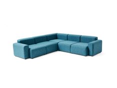 a blue sectional couch sitting on top of a white floor