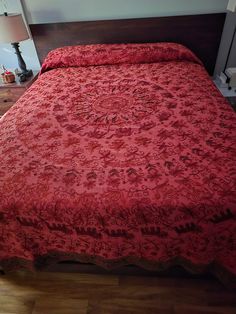 a red bedspread on a bed in a room