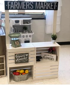 a store display with fruits and vegetables on it's shelves in front of a sign that says farmers market