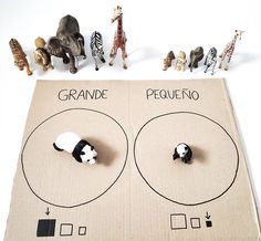 an open cardboard box with toy animals on it and the words grande pequeno