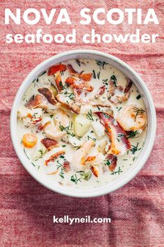 a white bowl filled with seafood chowder on top of a red cloth