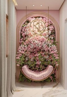 the entrance to a room with pink flowers and greenery on the wall, along with a round mirror