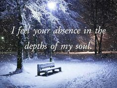 a park bench covered in snow at night