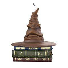 a harry potter hat sitting on top of three books