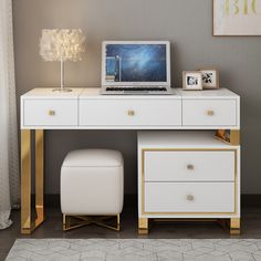 a laptop computer sitting on top of a desk next to a white chair and ottoman