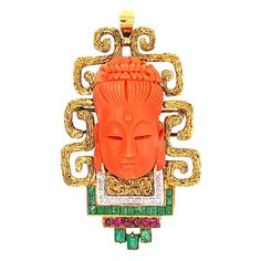 MAGNIFICENT large vintage Buddha pendant brooch in 18K yellow gold. This gorgeous pendant features a stunning Buddha carved in natural coral set in 18k yellow gold with elaborate swerling designs. The coral carving measures 34mm x 19.30 mm x 14.12 mm. The pendant is set with 15 single cut round diamonds, totaling approximately 0.15 ct., 18 rectangular green emeralds channel set totaling approximately 1.00 ct., and 6 round rubies totaling approximately 0.30 ct. The natural coral is beautifully ca Diy Jewelry Holder Wall, Jewelry Holder Wall, Antique Art Deco Jewelry, Carved Jewelry, Trifari Brooch, Figural Jewelry, Diy Jewelry Holder, Bodhi Tree, Vintage Trifari