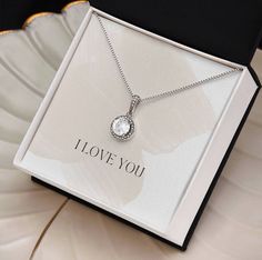 Surprise your loved one with a timeless and elegant gift. Our dazzling Eternal Hope Necklace features a cushion cut center cubic zirconia that will sparkle with every step. The center crystal is adorned with equally brilliant CZ crystals, ensuring a stunning look every wear. Wow her by gifting her an accessory that will pair with everything in her wardrobe! 14k white gold finish over stainless steel 8mm cushion-cut center cubic zirconia crystal 1.2mm accent CZ crystals Pendant dimensions: 0.6" (14mm) height / 0.5" (11.6mm) width Adjustable box chain length: 16" - 18" (40.64- 45.72cm) Lobster clasp Your piece is lovingly packaged in a complimentary soft touch box for easy gifting. Elevate your presentation by upgrading to the mahogany style luxury box, which features a brilliant LED spotlig Crystals Pendant, Hope Necklace, Birthday Special, First Mothers Day, Luxury Boxes, Gift For Wife, Eternal Love, Box Chain, Elegant Gift