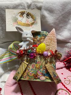 an ornament is sitting on top of a card holder with a bunny figurine