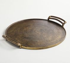 a round metal tray with handles on it