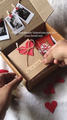 someone is opening up a valentine's card box