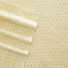 the fabric is yellow and white with hexagonal patterns