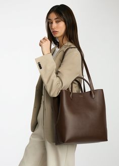 It’s time for a bag designed just for you. Every detail—from the quality of vegetable-tanned leather to the interior pockets to the silhouette—the Mila Tote was designed with the working professional in mind. Take her from the office with enough space for your 13" laptop, planner, and other everyday essentials to an after-work shopping date. By tethering the sides, you basically have two designs in one. Just like you, the Mila Tote is for the boss woman who can do it all! Travel Tote Bags For Women, Women’s Work Bag, Office Tote Bags For Women, Business Bags For Women, Corporate Bag, Work Tote Bags For Women, Best Work Bags For Women, Office Bags For Women, Laptop Bags For Women