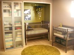 a baby's room with two cribs and a green rug