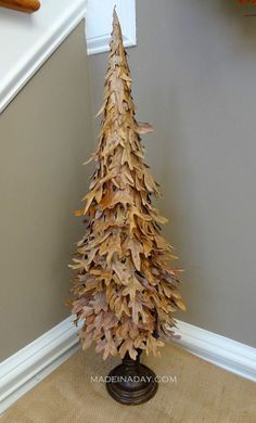 a small christmas tree made out of leaves