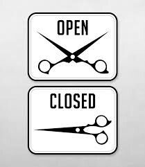 two white signs with scissors on them that say open and closed in red text below