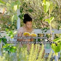 a woman sitting on a bench reading a book with the words those quiet moments when it's just you and god