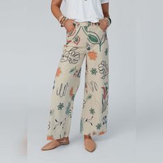 You'll love the unique and special print of the Toscana Printed Wide Leg Pants! You're going to want to rock these adorable pants with all your cute boho tops because they feature: Comfortable stretch denim fabric with so cute hand - drawn - inspired print throughout Flattering wide leg silhouette Classic high - rise waistline with a zipper - fly closure Convenient side and back patch pockets and belt loops Pair with: Tricks Up Her Sleeve Sweater, Mulholland Draped Cardigan, and Kapalua Bay Adju Pants With Flowers, Beige Linen Pants, Draped Cardigan, Basic White Tee, Three Bird Nest, Floral Doodle, Denim Art, Stretch Denim Fabric, Printed Wide Leg Pants