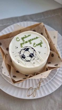 a cupcake on a paper plate with the words congratulations written in green and white