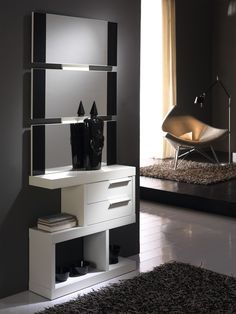 a modern white and black bathroom vanity with lights on the mirror, in front of a large window