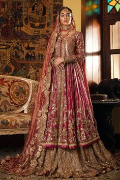 a woman in a red and gold bridal gown