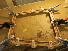 some tools are sitting on top of a wooden table in the process of being assembled