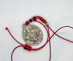 Three different variations of Ganesh:  1) brown and brass micro pave Ganesh elephant crystal tassel green silk cord necklace with malachite accent bead. Adjustable with woven Tibetan knot slide made by me. Wear it long or short.  2) red chord with round silver charm Ganesh with red carnelian beads on red silk cord necklace. Adjustable with woven Tibetan knot slide made by me. Wear it long or short.  3) blue chord silver Ganesh elephant Tibetan charm and tiger eye accent bead. Adjustable with wov Traditional Adjustable Cord Festival Jewelry, Adjustable Gemstone Beads Jewelry For Festivals, Bohemian Necklace With Adjustable Silk Cord, Adjustable Bohemian Necklace With Silk Cord, Bohemian Silk Cord Adjustable Necklaces, Bohemian Adjustable Silk Cord Necklace, Traditional Jewelry With Sliding Knot For Festival, Handmade Adjustable Silk Cord Necklaces, Spiritual Jewelry With Sliding Knot For Festivals