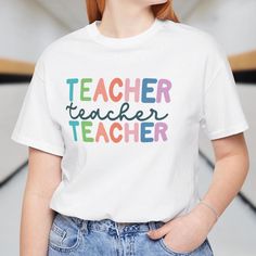 This Cute Teacher Shirt is perfect for everyday wear and makes a great gift for teachers. Featuring a colorful design, this teacher t-shirt is ideal for a Teacher Life Outfit or Back to School Shirt. 🏫Everyday Wear 🏫Back to School, End of Year Gift, Teacher Appreciation 📣Sizing: XS - 4XL 🎨Product Details:  ✨Bella+Canvas ✨100% Cotton and Pre-shrunk ✨Unisex Sizing 📦 Shipping Information: 🚚Standard (US) is 2-5 days 🚚Standard (Worldwide) is 10-30 days 🚚Economy is 4-8 days (US) 🛍️How To Order:  📸 Review all photos 👆🏼 Select the Design and Size 🛒 Click Add to Cart 🧼Care Instructions 🫧 Machine washing with cold water 🫧 Tumble dry on low or air drying is suitable 📣Other Products to Love 💖Tortured Teacher t-shirt https://www.etsy.com/listing/1712772234/the-tortured-teachers-depart School Spirit Cotton T-shirt As Gift, Back To School Graphic Tee For Teaching, Cotton T-shirt For Teaching, Back To School, Multicolor Cotton T-shirt For Everyday, Everyday Multicolor Cotton T-shirt, Multicolor School T-shirt With Text Print, School Multicolor Text Print T-shirt, Multicolor Text Print T-shirt For School, White Pre-shrunk T-shirt