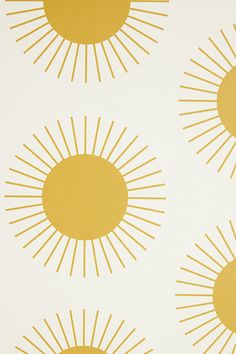 four yellow and white sunbursts on a white wallpaper design with gold foiling