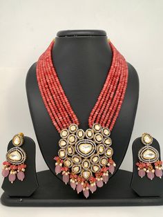 Kundan AD Pendent with Pink Onyx Beads Necklace Necklace Length : 16 Inches; Earring Length : 2.5 Inches Kundan Necklaces With Dangling Beads For Gift, Traditional Pink Necklaces With Colorful Beads, Pink Kundan Necklace With Round Beads, Beaded Kundan Pendant Necklace For Celebration, Pink Polished Beads Necklace For Celebration, Traditional Pink Necklaces With Dangling Beads, Festive Beaded Pendant Bridal Necklace, Kundan Necklaces With Faceted Round Beads, Kundan Necklaces With Faceted Beads