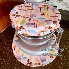 a close up of a pot holder on a counter top with an umbrella print cover