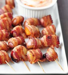 bacon wrapped chicken on skewers with dip in the background and text that reads yummy finger food recipe