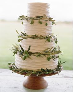 a wedding cake with greenery on top and the words 25 best wedding cakes of 2015