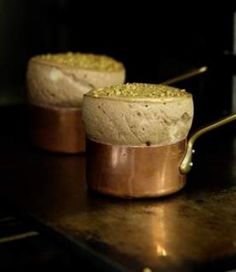 two pots filled with food sitting on top of a stove