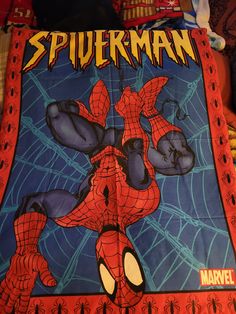 the spiderman blanket is laying on top of a bed