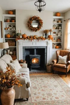 a living room filled with furniture and a fire place in the middle of it's wall