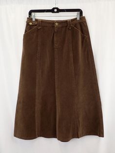 Y2K Eddie Bauer brown corduroy skirt, Vintage a line mid length brown skirt, college preppy fashion, clueless academic look, festival wear Step into the realm of timeless elegance with our Y2K Eddie Bauer Brown Corduroy Skirt, a vintage treasure that effortlessly captures the essence of collegiate preppy fashion. Crafted by the esteemed Eddie Bauer brand, this A-line mid-length skirt is a nod to classic silhouettes and sophisticated style. Embrace the clueless academic look with this charming skirt, perfect for channeling the spirit of iconic 90s films. Its rich brown corduroy fabric exudes warmth and texture, while the A-line cut flatters your figure with a touch of retro flair. Style this versatile piece in myriad ways to suit any occasion. For an effortlessly chic ensemble, pair it with Brown Cotton Skirt For Fall, Vintage Corduroy Skirt For Fall, Brown Long Skirt, Retro Brown Skirt, Knee-length Brown Lined Skirt, Vintage Brown Skirted Bottoms, Brown Corduroy Skirt, Vintage Cotton Brown Skirt, High-waisted Brown Corduroy Skirt