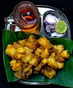 a plate with some food on it next to a drink