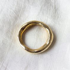 Our take on a classic, gold band with added dimension. A weighty and substantial piece, this gold ring band is suitable as a wedding ring or commitment ring for men or women. You can stack multiples for a modern look or pair with our Little Butte Ring. The irregularity harkens back to an ancient past and has a very wabi sabi feeling to it. This beautiful, organic ring was first created by hand in wax and then cast in recycled solid 14k yellow gold and polished to a high shine. Please reach out if you would like the ring made in different metals like white gold or rose gold. Made to order; therefore please allow 2-3 weeks to ship. Can be made in custom sizes not listed here. Handmade in Downtown Los Angeles. Shop the Wisdom Ring in brass, gold plated and sterling silver. Commitment Rings, Organic Rings, Gold Armband, Ringe Gold, Organic Ring, Gold Band Ring, Ring For Men, Classic Gold, 14k Gold Ring