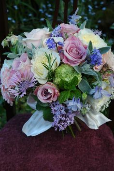 a bouquet of flowers sitting on top of a chair