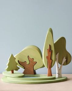 a wooden toy with trees on top of it