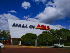 a white van is parked in front of a building with the word mall of asia on it