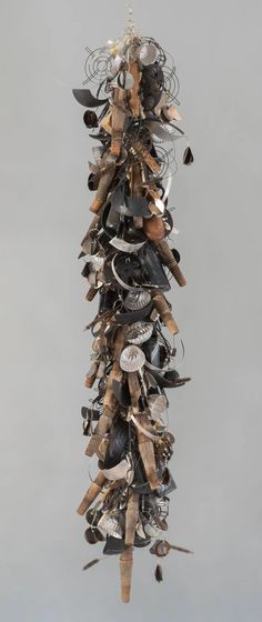 a sculpture made out of various objects hanging from the ceiling